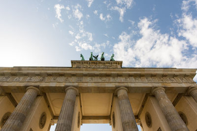 Low angle view of historical building against cloudy sky