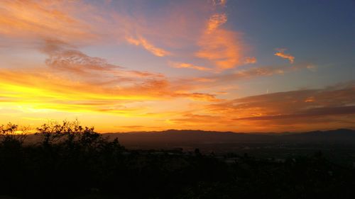 Scenic view of landscape against sky at sunset