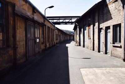 Empty road along buildings