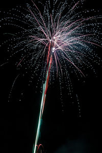 Low angle view of firework display at night