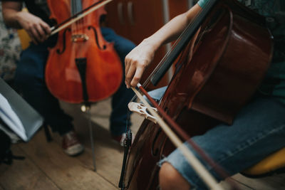 Midsection of cellist playing cello