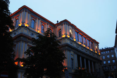 Low angle view of illuminated building against clear sky