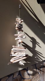 Close-up of rope tied on wooden table against wall