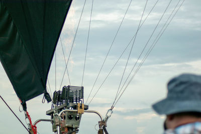 Rear view of people on sailboat against sky
