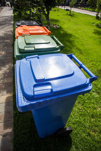 High angle view of garbage can on field