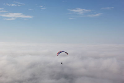 Parachute flying over cloudscape