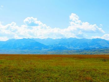Scenic view of landscape against cloudy sky