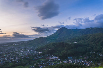 Scenic view of sea and mountains against sky