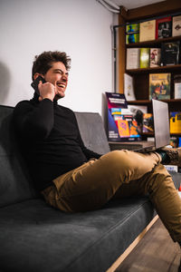 Young man using mobile phone at home