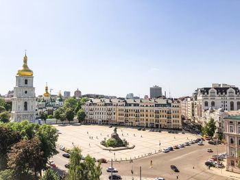 Buildings in city against clear sky