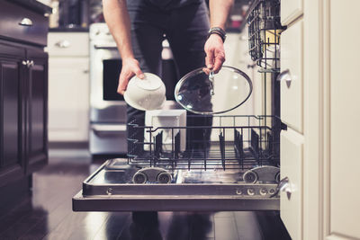 Midsection of man having food at home