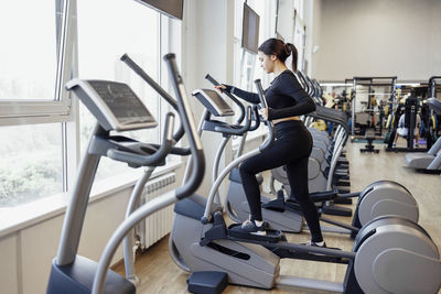 Side view of man exercising in gym