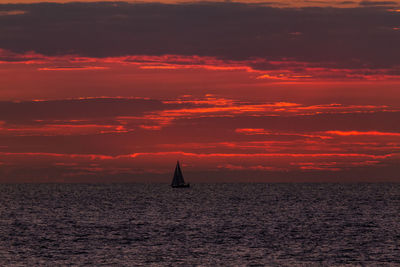 Scenic view of sea against orange sky