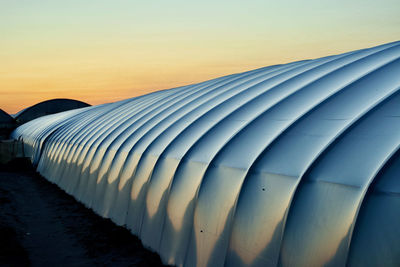 Scenic view of a greenhouse against clear sky during sunset