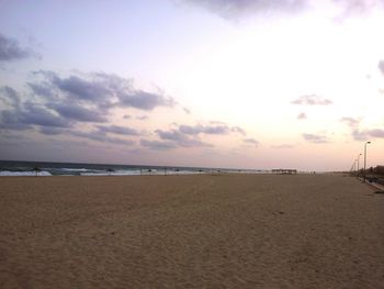 Scenic view of beach against sky during sunset