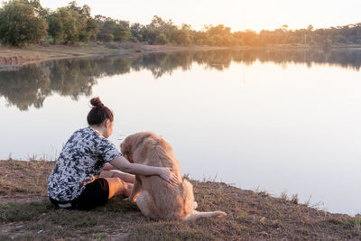 Man with dog sitting in a lake