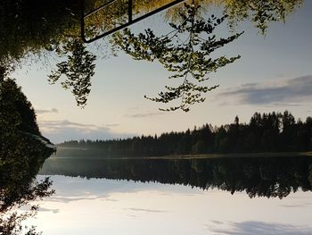 Scenic view of lake against sky at sunset