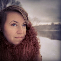 Close-up of thoughtful woman wearing fur coat