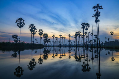 Scenic view of lake against sky at sunset