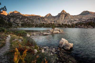 Scenic view of lake and mountains against clear sky