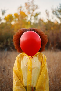 Close-up of red balloons on field