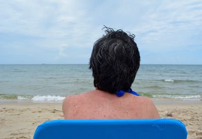 Rear view of woman looking at sea shore