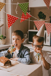 The boys are celebrating their birthday. paraphernalia of children's birthday. 