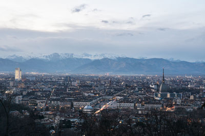 High angle view of city against cloudy sky