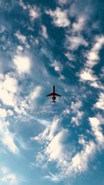 Low angle view of airplane against sky