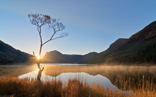 Scenic view of lake against clear blue sky