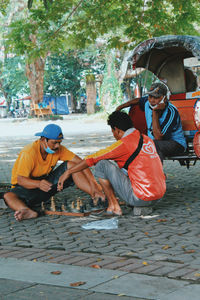 People on sidewalk against trees