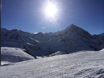 Scenic view of snow covered mountains against sky