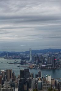 Aerial view of city by sea against sky