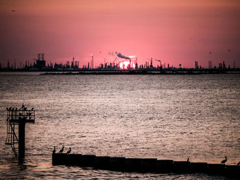 Scenic view of river against sky during sunset