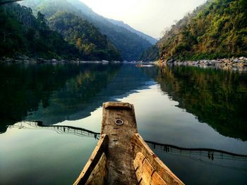 Scenic view of lake by mountain against sky