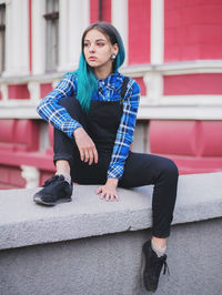 Portrait of young woman sitting outdoors