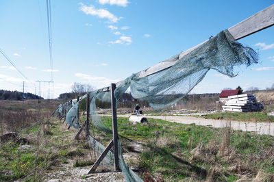 Railroad track amidst field against sky