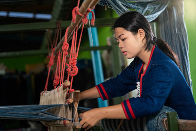 Woman working on loom