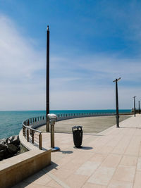 Promenade by sea against sky