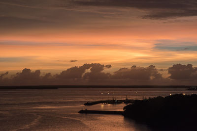 Scenic view of sea against orange sky