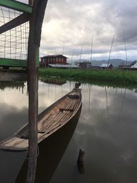 Boats moored in water against sky