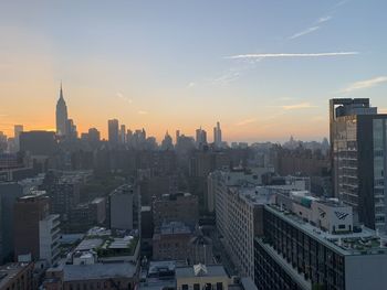 Aerial view of buildings in city during sunset