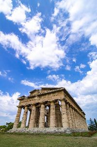 Low angle view of historical building against clear blue sky  , temple of paestum. italy