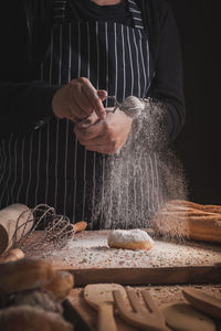 Midsection of man preparing food