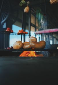 Close-up of potatoes on cooking pan over fire