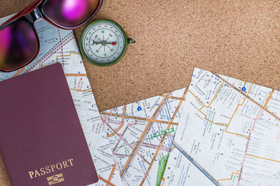 Directly above shot of passport on map by various objects on table