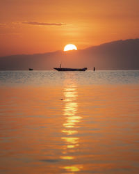 Scenic view of sea against orange sky