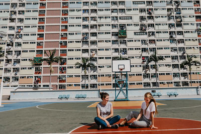 People sitting on office building in city