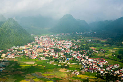 High angle view of townscape by tree mountain