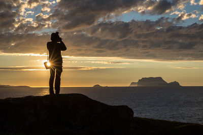 Silhouette man overlooking scenic sky